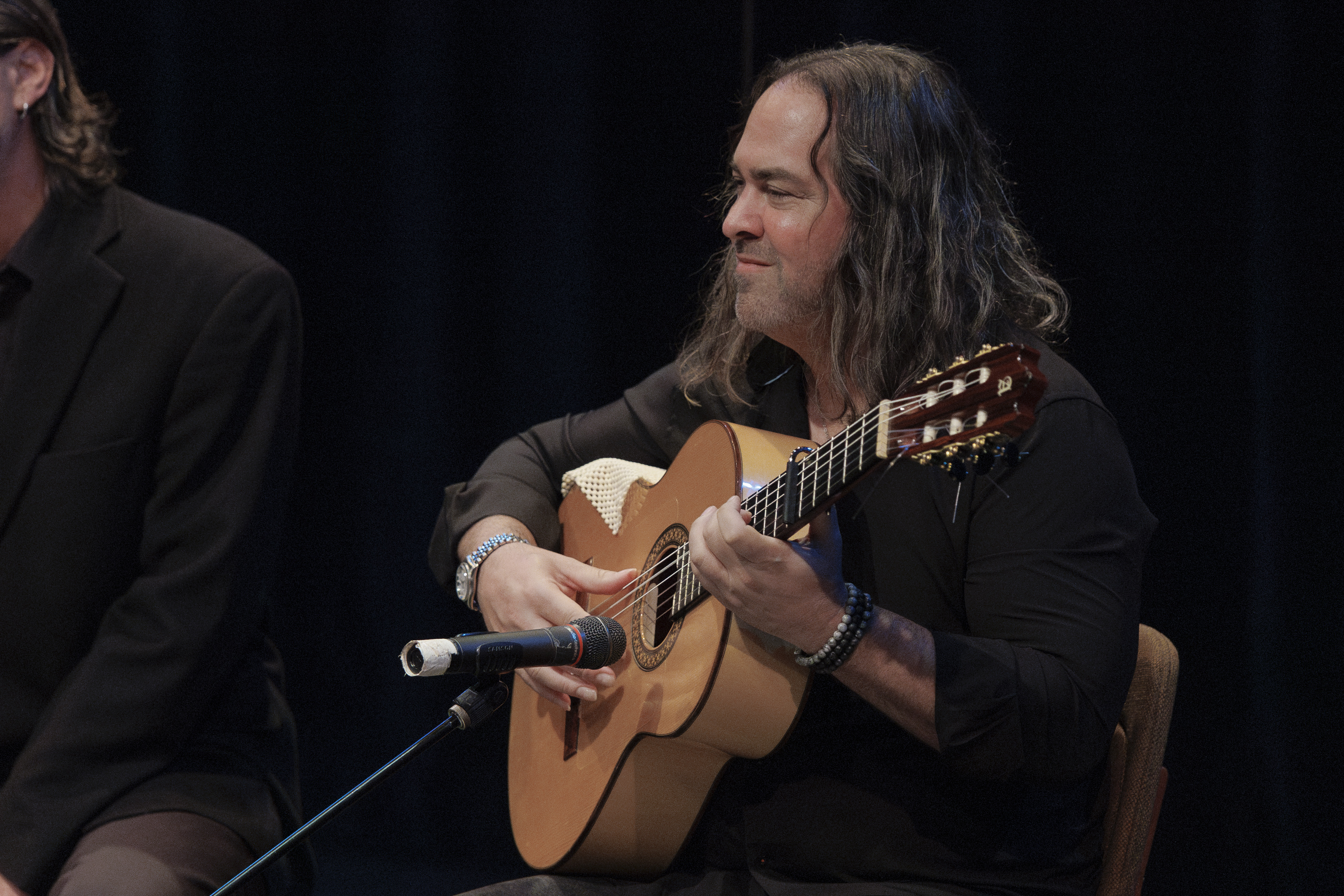 Albert Marques playing the guitar onstage at Bach To Blues.