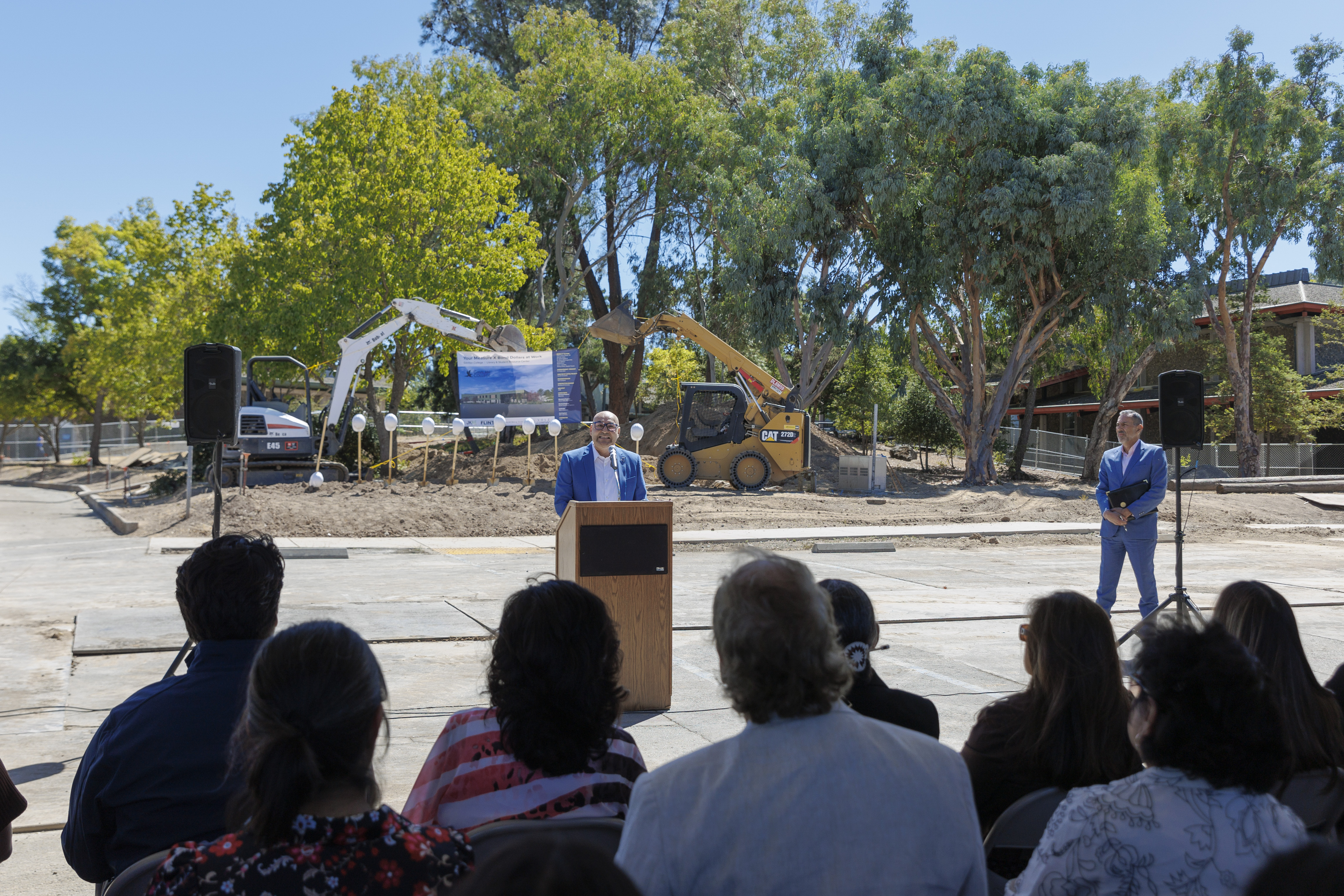 Dr. Pedro Avila speaking at a podium in front of a group of people