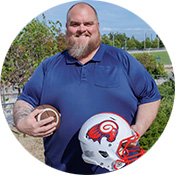 Image of Joffre Longoria holding a football and helmet